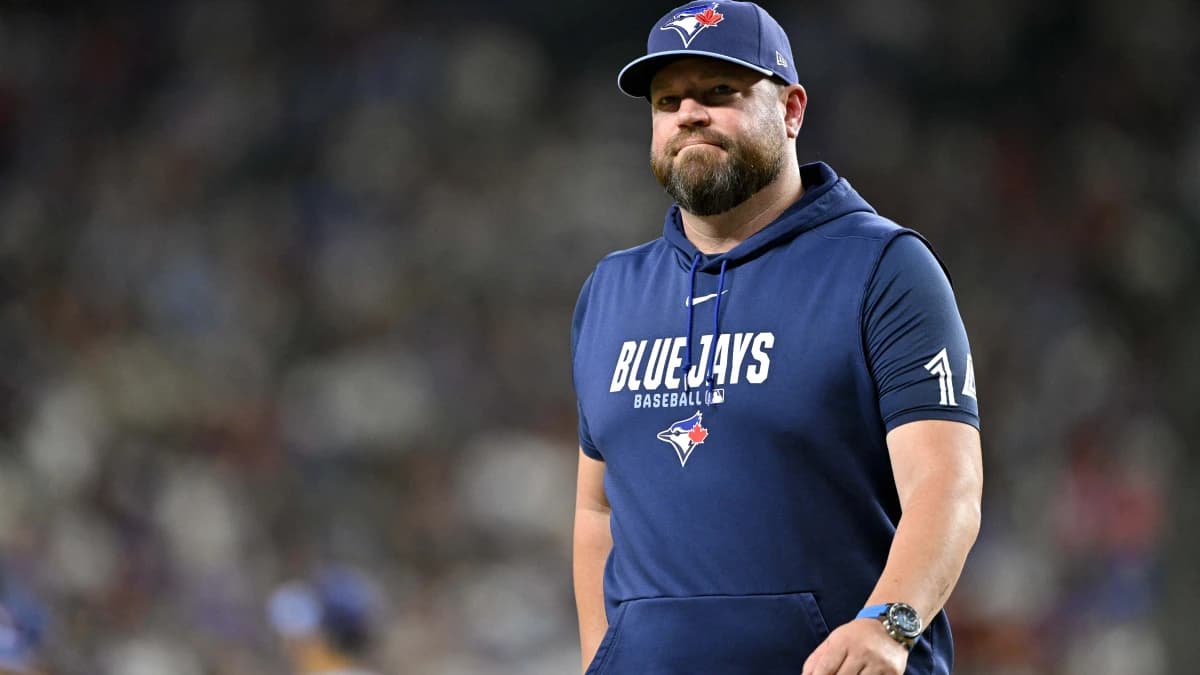 Toronto Blue Jays manager John Schneider walks back to the dugout during the sixth inning against the Texas Rangers at Globe Life Field.