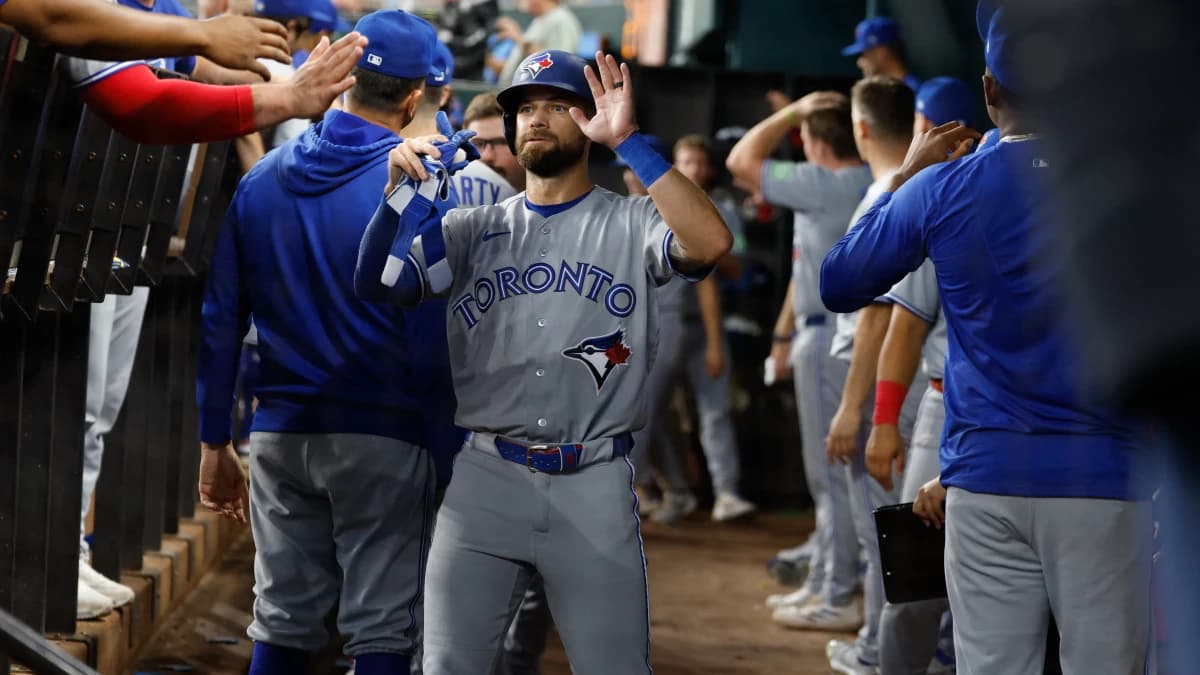 Toronto Blue Jays right fielder Nathan Lukes (38) is congratulated by teammates in the dugout after scoring a run during the seventh inning against the Texas Rangers at Globe Life Field.