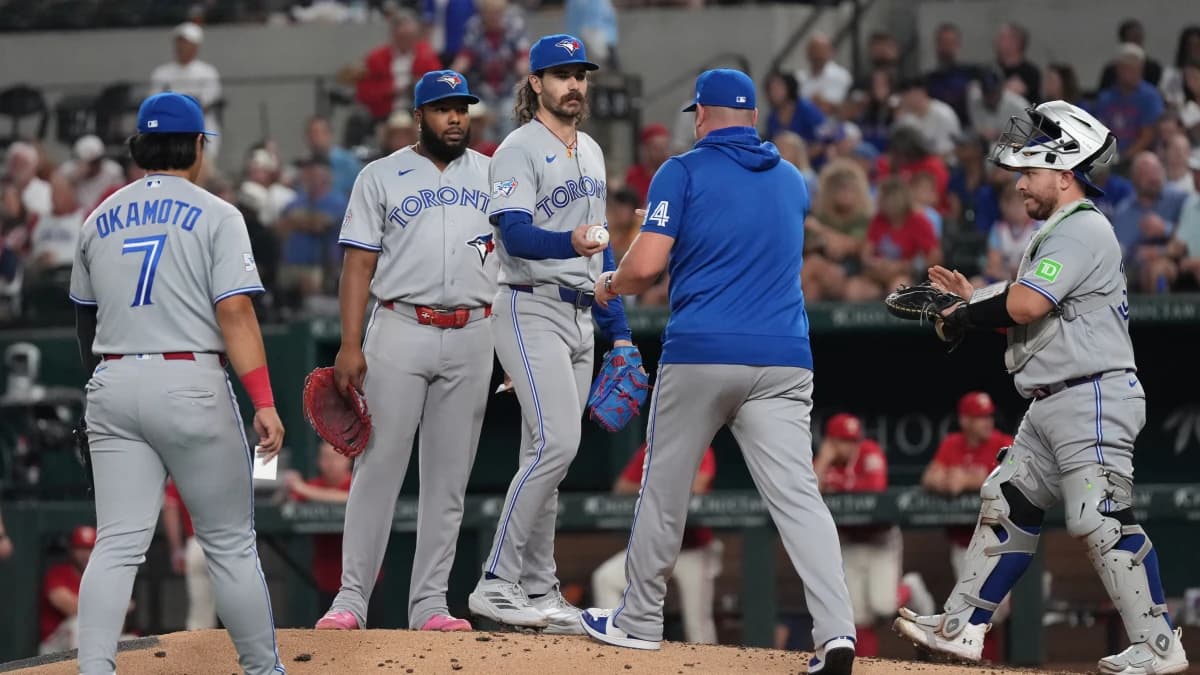 Toronto Blue Jays pitcher Dylan Cease (84) hands the baseball to manager John Schneider (14) as he is relieved during the third inning against the Texas Rangers at Globe Life Field.