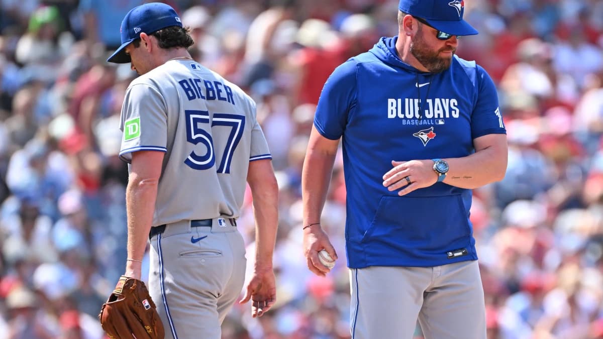 Toronto Blue Jays manager John Schneider (14) take the ball from pitcher Shane Bieber (57) against the Philadelphia Phillies during the sixth inning at Citizens Bank Park.