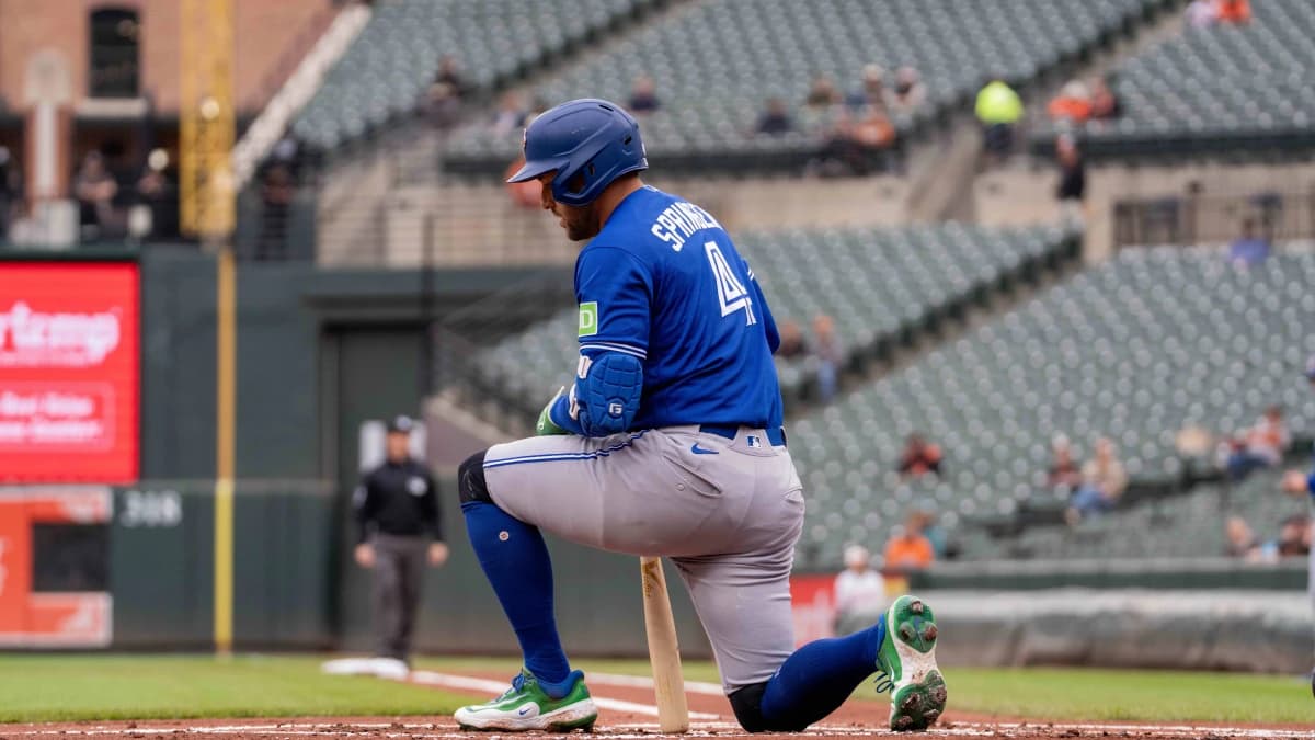 Toronto Blue Jays designated hitter George Springer (4) takes a knee after swinging at a strike during the first inning at Oriole Park at Camden Yards