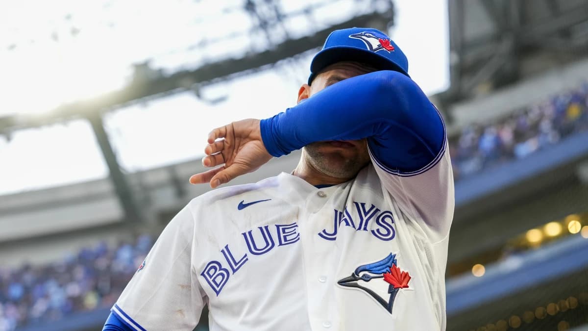Toronto Blue Jays designated hitter George Springer (4) wipes tears away after playing his final MLB game against the Cincinnati Reds at Rogers Centre