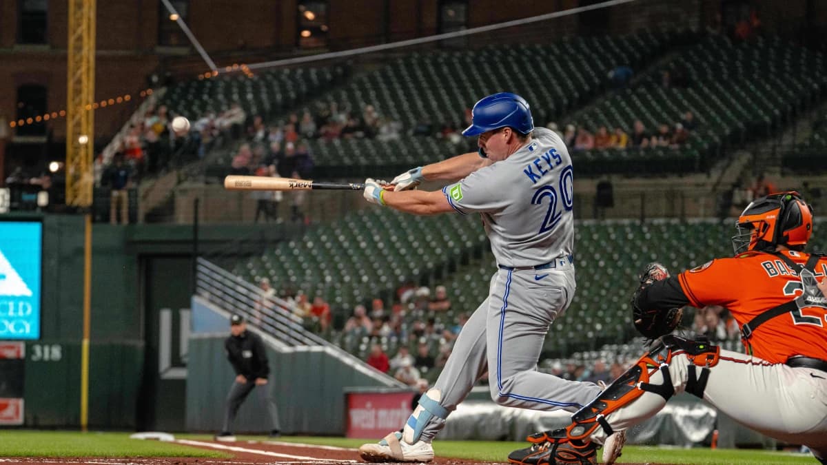 Toronto Blue Jays designated hitter Sean Keys (20) hits a sacrifice fly during the first inning at Oriole Park at Camden Yards.