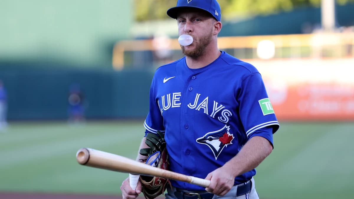 Toronto Blue Jays left fielder Myles Straw (3) walks toward the dugout while blowing a bubble with chewing gum and holding a bat before a game against the Athletics at Sutter Health Park