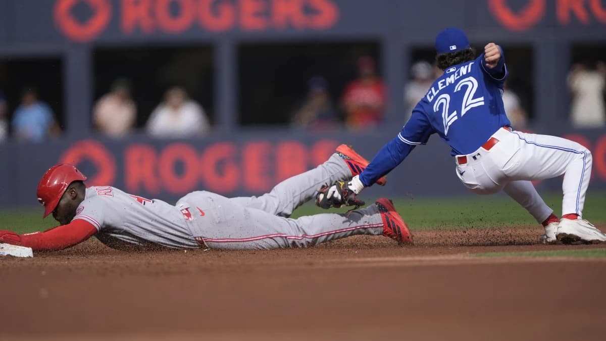 Toronto Blue Jays second baseman Ernie Clement (22) catches Cincinnati Reds right fielder Hector Rodriguez (43) trying to steal second base during the second inning at Rogers Centre.