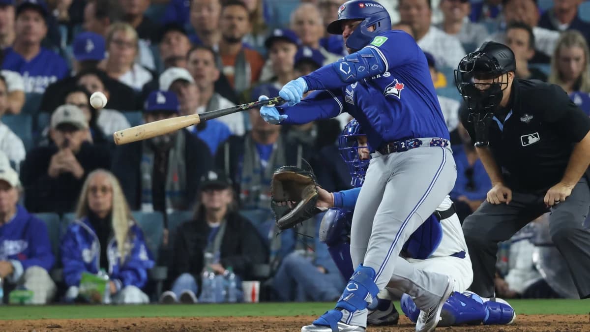 Toronto Blue Jays first baseman Ty France singles during the tenth inning against the Los Angeles Dodgers in game three of the 2025 MLB World Series at Dodger Stadium.