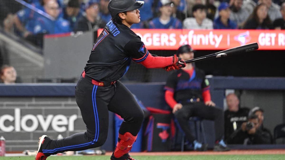 Toronto Blue Jays third baseman Kazuma Okamoto (7) hits a three RBI double against the Cincinnati Reds in the seventh inning at Rogers Centre.