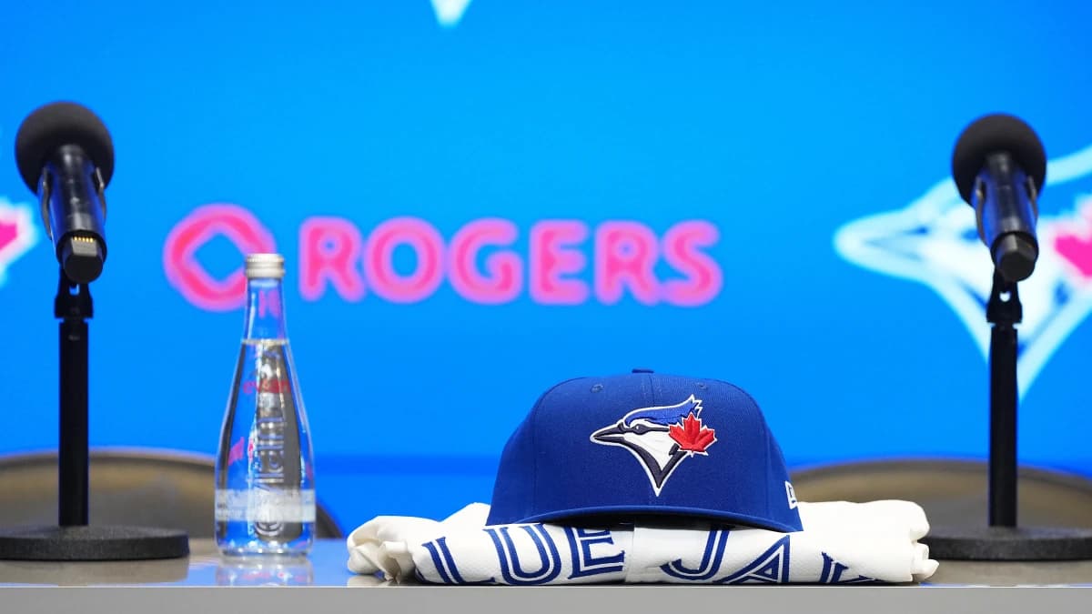 A Toronto Blue Jays cap and jersey sit on the table before the Toronto Blue Jays press conference at Rogers Centre.
