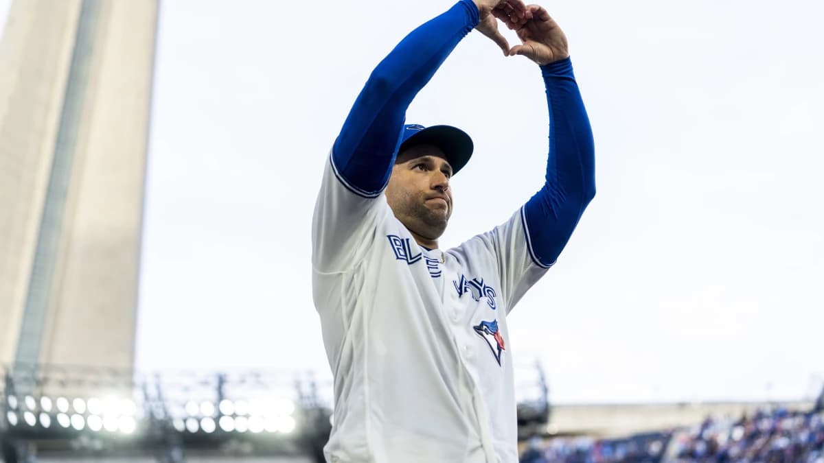 Toronto Blue Jays designated hitter George Springer (4) makes a heart shape with his hands to salute the fans after defeating the Cincinnati Reds at Rogers Centre.