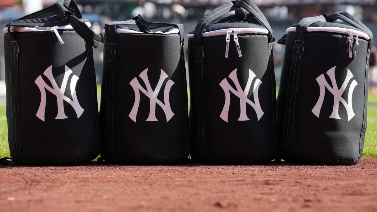 Equipment bags with the New York Yankees logo sit on the field before the game against the San Francisco Giants at Oracle Park.