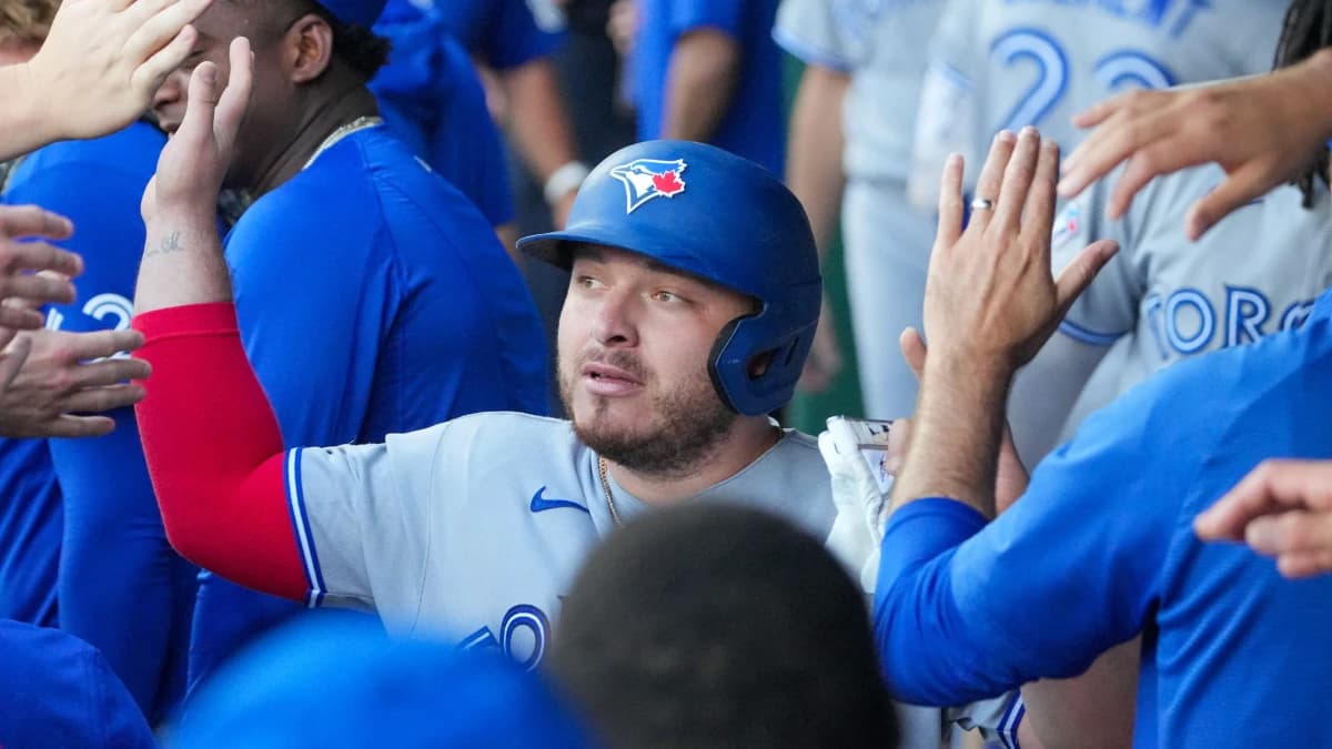 Toronto Blue Jays catcher Alejandro Kirk (30) celebrates in the dugout after scoring against the Kansas City Royals during the first inning at Kauffman Stadium