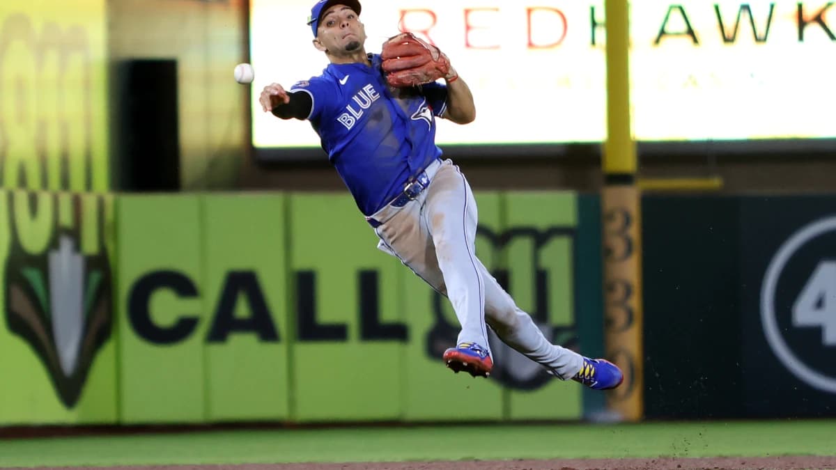 Toronto Blue Jays short stop Andres Gimenez (0) throws a late ball to first base against Athletics first baseman Jeff McNeil (not pictured) during the ninth inning at Sutter Health Park.