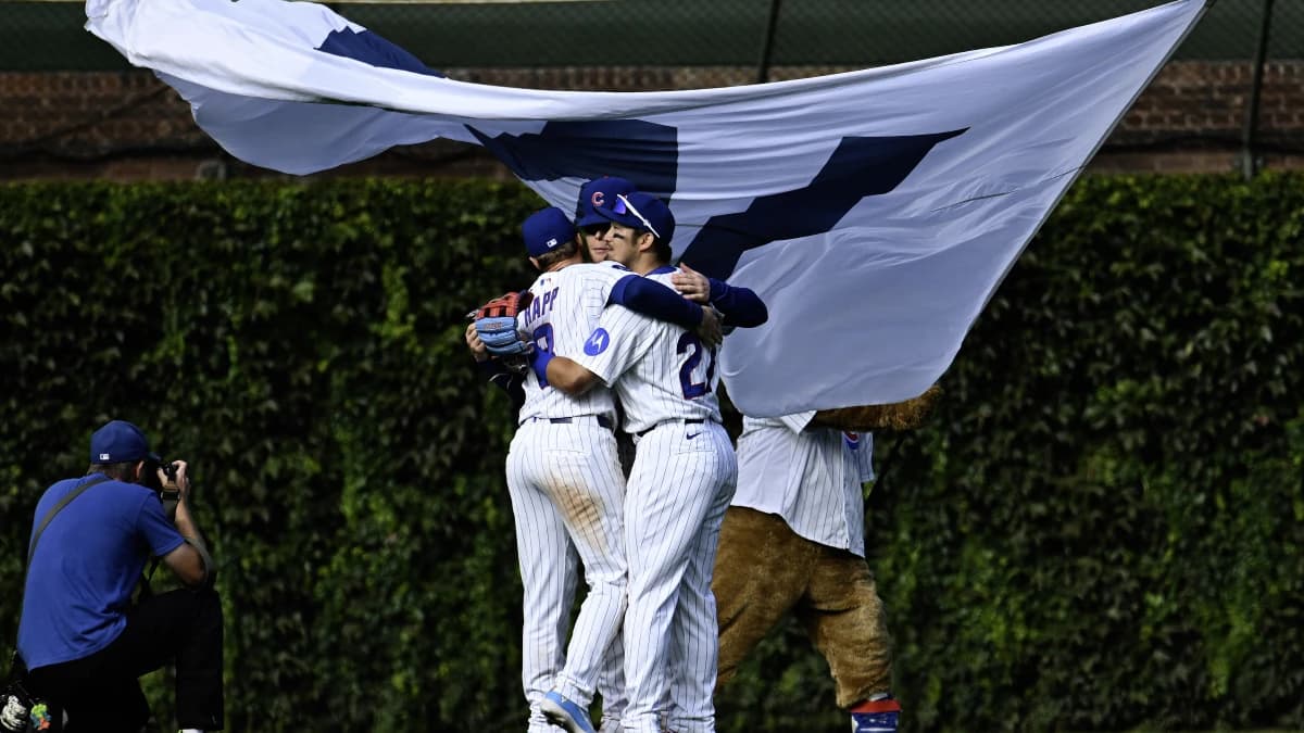 Chicago Cubs left fielder Ian Happ (8), center fielder Pete Crow-Armstrong (4) and right fielder Seiya Suzuki (27) hug after the game against the Miami Marlins at Wrigley Field