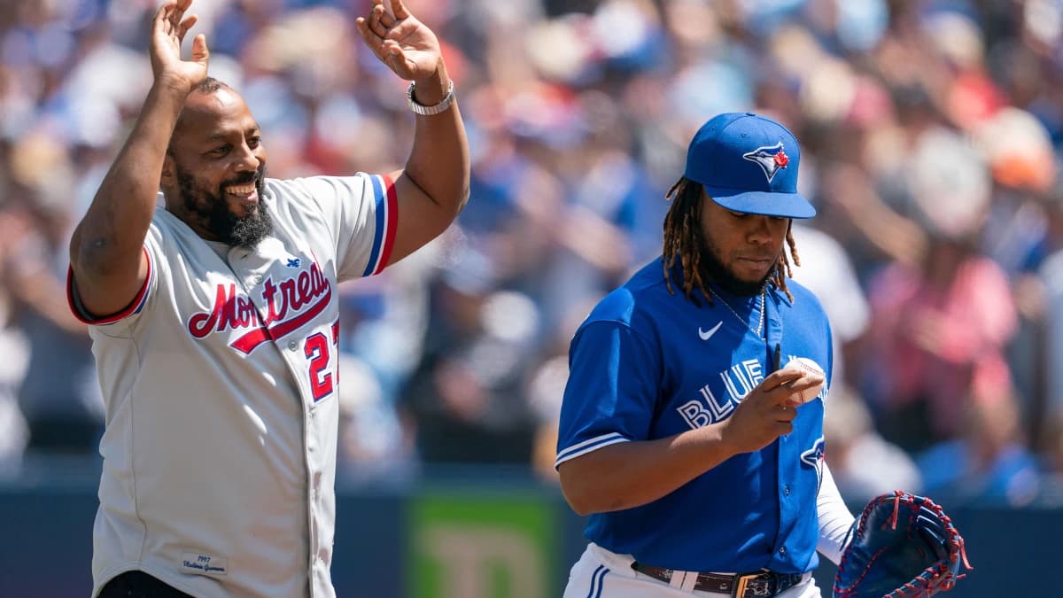 Montreal Expos former player Vladimir Guerrero Sr. acknowledges the crowd as Toronto Blue Jays designed hitter Vladimir Guerrero Jr. (27) looks at the first pitch ball against the Tampa Bay Rays at Rogers Centre