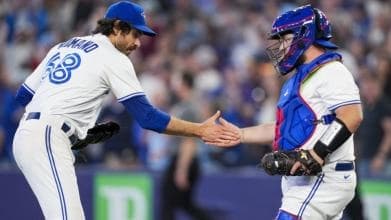 Jordan Romano celebreating with Catcher Alejandro Kirk.