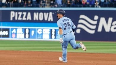 Daulton Varsho rounding the bases after a homerun at home.