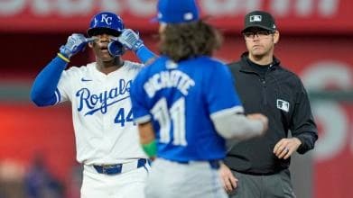 Dairon Blanco celebrating to his dugout in front of Bo Bichette after hitting a double.