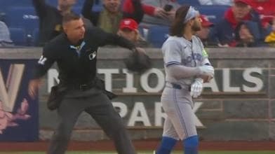 Bo Bichette walking to the dugout after slamming helmet and being ejected.