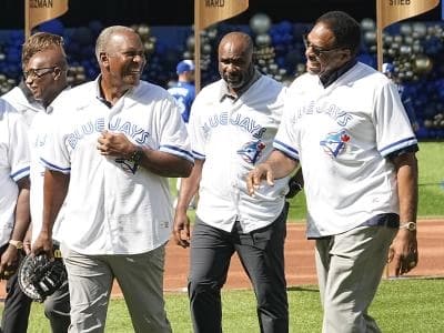Toronto Blue Jays former players Joe Carter (left) and Dave Winfield (right) come off the field after a ceremony for the 1992 World Series champion Toronto Blue Jays before a game against the Los Angeles Angels at Rogers Centre.