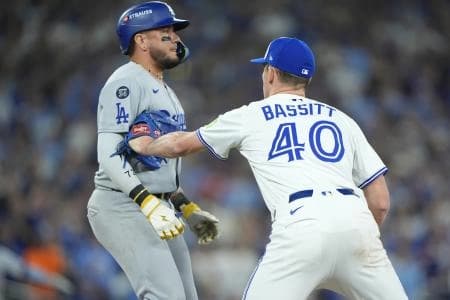 Toronto Blue Jays pitcher Chris Bassitt (40) tags out Los Angeles Dodgers second baseman Miguel Rojas (72) in the sixth inning during game seven of the 2025 MLB World Series at Rogers Centre.