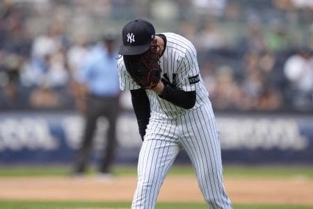 New York Yankees pitcher Luke Weaver (30) reacts to getting a strikeout to end the inning against the Chicago Cubs during the eighth inning at Yankee Stadium.