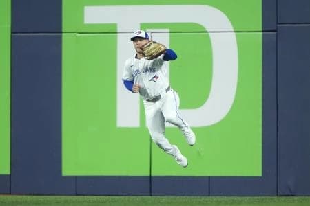 Toronto Blue Jays center fielder Daulton Varsho (5) fields a ground ball hit by Los Angeles Dodgers two-way player Shohei Ohtani (17) in the first inning during game seven of the 2025 MLB World Series at Rogers Centre.