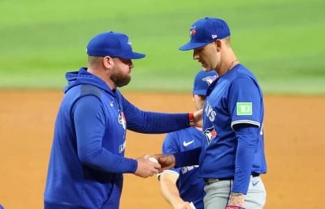 Toronto Blue Jays manager John Schneider (14) removes Toronto Blue Jays starting pitcher Bowden Francis (44) during the sixth inning against the Texas Rangers at Globe Life Field.