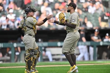 San Diego Padres pitcher Robert Suarez (75) celebrates with catcher Freddy Fermin (54) after defeating the Chicago White Sox during the ninth inning at Rate Field.