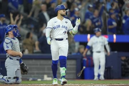 Toronto Blue Jays designated hitter Bo Bichette (11) reacts after hitting a three run home run against the Los Angeles Dodgers in the third inning during game seven of the 2025 MLB World Series at Rogers Centre.