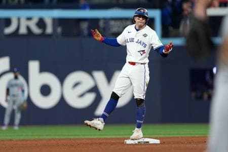 Toronto Blue Jays third baseman Ernie Clement (22) reacts after hitting a double against the Los Angeles Dodgers in the eighth inning for game seven of the 2025 MLB World Series at Rogers Centre.