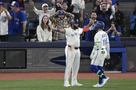 Toronto Blue Jays designated hitter Bo Bichette (11) celebrates with first baseman Vladimir Guerrero Jr. (27) after hitting a three run home run against the Los Angeles Dodgers in the third inning during game seven of the 2025 MLB World Series at Rogers Centre.