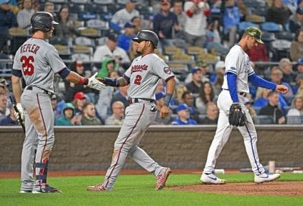 Minnesota Twins Luis Arraez (2) celebrates with right fielder Max Kepler (26) after scoring a run against Kansas City Royals pitcher Foster Griffin (right) during the ninth inning at Kauffman Stadium.