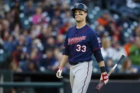 Minnesota Twins first baseman Justin Morneau (33) walks back to the dugout after striking out during the ninth inning against the Detroit Tigers at Comerica Park. Detroit won 8-0.