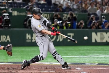 Yomiuri Giants first baseman Kazuma Okamoto (25) hits a single against the Chicago Cubs during the second inning at Tokyo Dome.