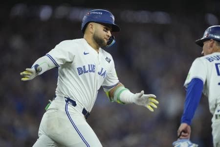 Toronto Blue Jays designated hitter Bo Bichette (11) reacts as he runs the bases after hitting a three run home run against the Los Angeles Dodgers in the third inning during game seven of the 2025 MLB World Series at Rogers Centre.