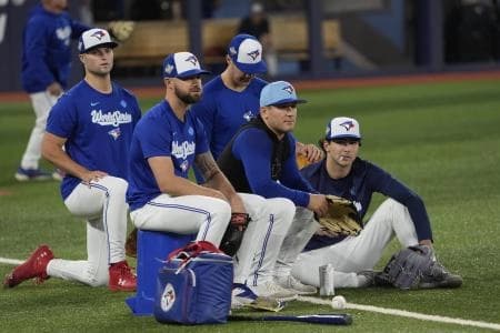 Toronto Blue Jays right fielder Nathan Lukes (left) and center fielder Daulton Varsho (center) and outfielder Joey Loperfido (right) wait for batting pratice on media day before game one of the World Series at Rogers Centre.