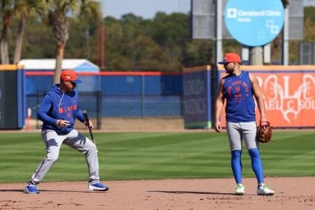 New York Mets shortstop Bo Bichette (19) works with manager Carlos Mendoza (64) during spring training at Clover Park.