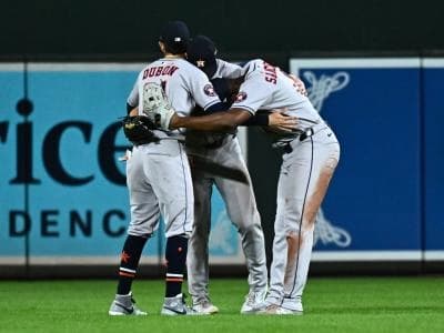 Houston Astros outfielders Mauricio Dubón (14) Jesús Sánchez (4) and Jacob Melton (31) celebrate a win against the Baltimore Orioles at Oriole Park at Camden Yards.