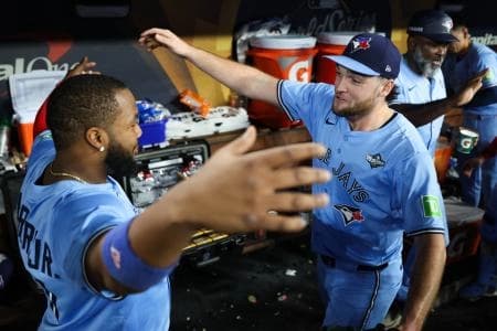 Toronto Blue Jays pitcher Trey Yesavage (39) celebrates with Toronto Blue Jays first baseman Vladimir Guerrero Jr. (27) after the game against the Los Angeles Dodgers during game five of the 2025 MLB World Series at Dodger Stadium
