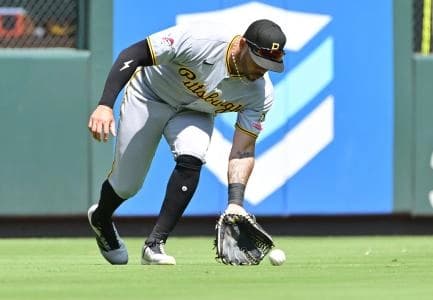 Pittsburgh Pirates left fielder Tommy Pham (28) scoops up a ball hit by the St. Louis Cardinals to left field at Busch Stadium.
