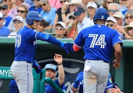 Toronto Blue Jays designated hitter Eloy Jimenez (74) scores a run by Toronto Blue Jays catcher Brandon Valenzuela (59) sacrifice hit at JetBlue Park at Fenway South.