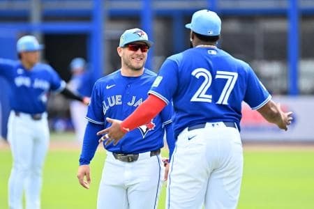Toronto Blue Jays center fielder Daulton Varsho (5) talks with first baseman Vladimir Guerrero Jr. (27) before the game against the Florida Marlins during spring training at TD Ballpark.