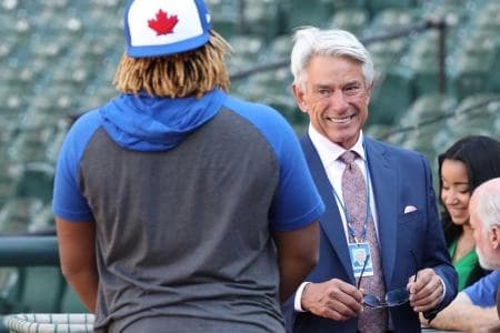 Toronto Blue Jays broadcaster Buck Martinez talks with third baseman Vladimir Guerrero Jr. (27) prior to the game against the Baltimore Orioles at Oriole Park at Camden Yards.