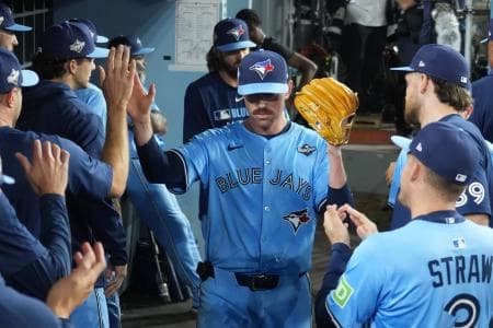 Toronto Blue Jays pitcher Shane Bieber (57) reacts in the dugout after being relieved in the sixth inning against the Los Angeles Dodgers during game four of the 2025 MLB World Series at Dodger Stadium.