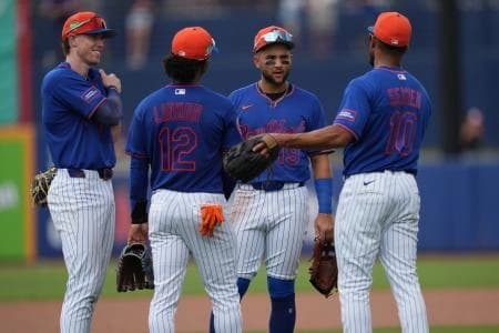 (l to rt) New York Mets third baseman Brett Baty (7), shortstop Francisco Lindor (12), shortstop Bo Bichette (19) and second baseman Marcus Semien (10) gather during a pitching change in the fourth inning against the Toronto Blue Jays at Clover Park.