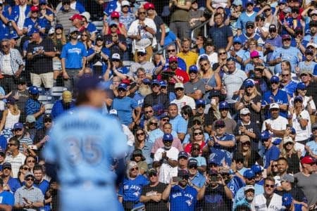 Toronto Blue Jays fans stand up during the ninth inning before pitcher Ryan Borucki (35) sets to pitch to the Baltimore Orioles at Rogers Centre.