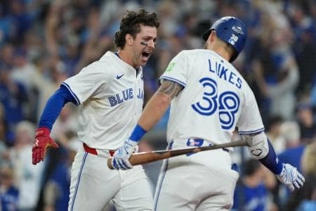 Toronto Blue Jays third baseman Ernie Clement (22) reacts after scoring a run against the Los Angeles Dodgers in the sixth inning for game seven of the 2025 MLB World Series at Rogers Centre.
