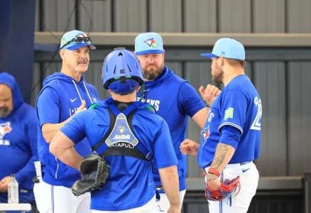 Toronto Blue Jays pitcher Yariel Rodriguez (29) talks with catcher Alejandro Kirk (30), pitching coach Pete Walker (41) and manager John Schneider (14) after he throws a bullpen session for spring training practice at Blue Jays Player Development Complex.