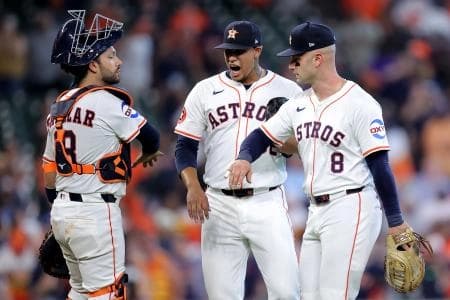 Houston Astros first baseman Christian Walker (8) is congratulated by catcher Cesar Salazar (18) and pitcher Bryan Abreu (52) after the final out against the Colorado Rockies at Daikin Park.