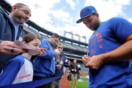 New York Mets third baseman Bo Bichette (19) signs autographs before an opening day game against the Pittsburgh Pirates at Citi Field.